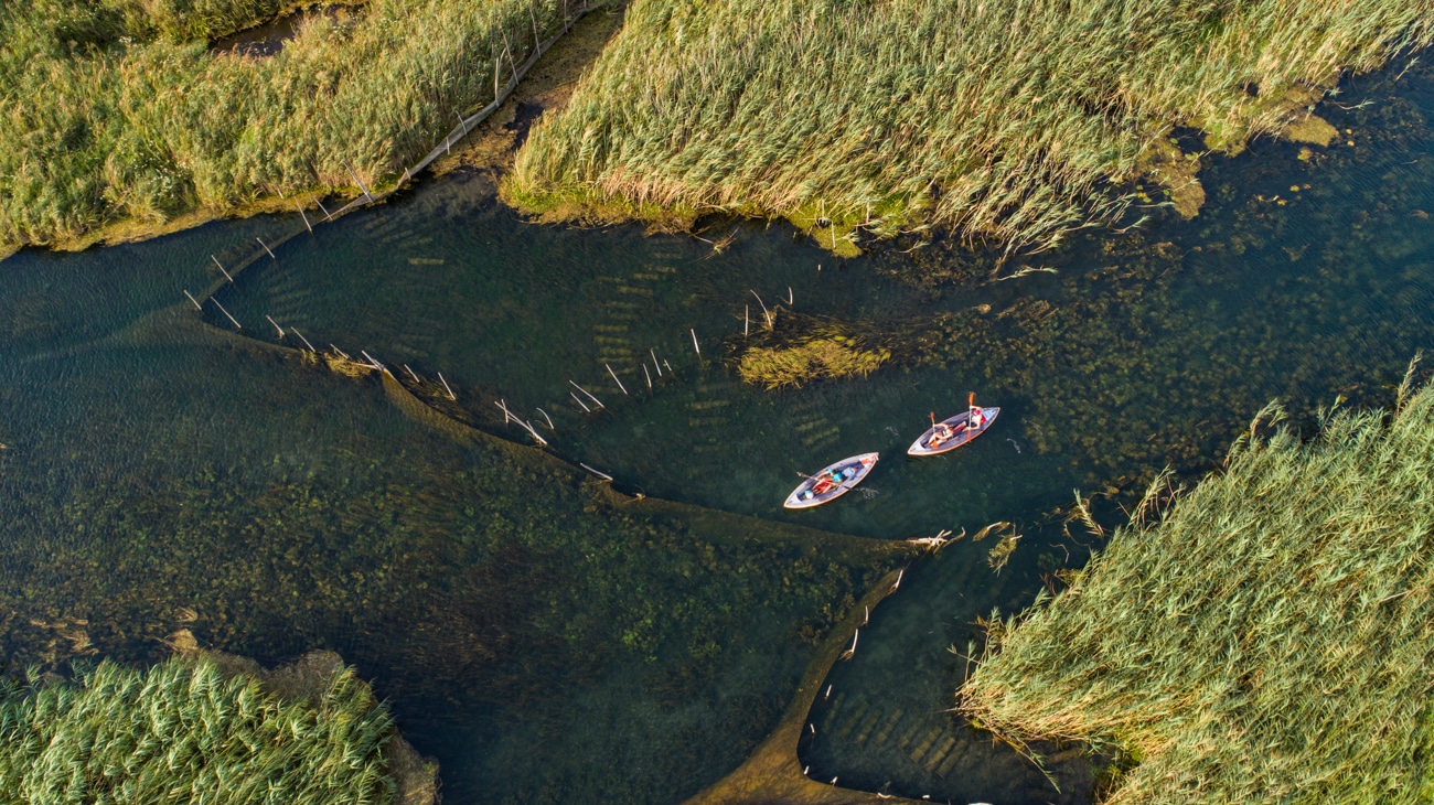 Aerial view of kayakers paddling on Norin river in Neretva valley. Situated near the city of Metković in Dalmatia, Croatia.